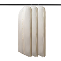 Natural cotton garment bag with button closure, hanging on a wooden rail