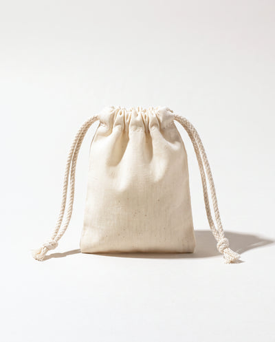 Plain natural cotton muslin double drawstring bag with braided cotton cords, white background