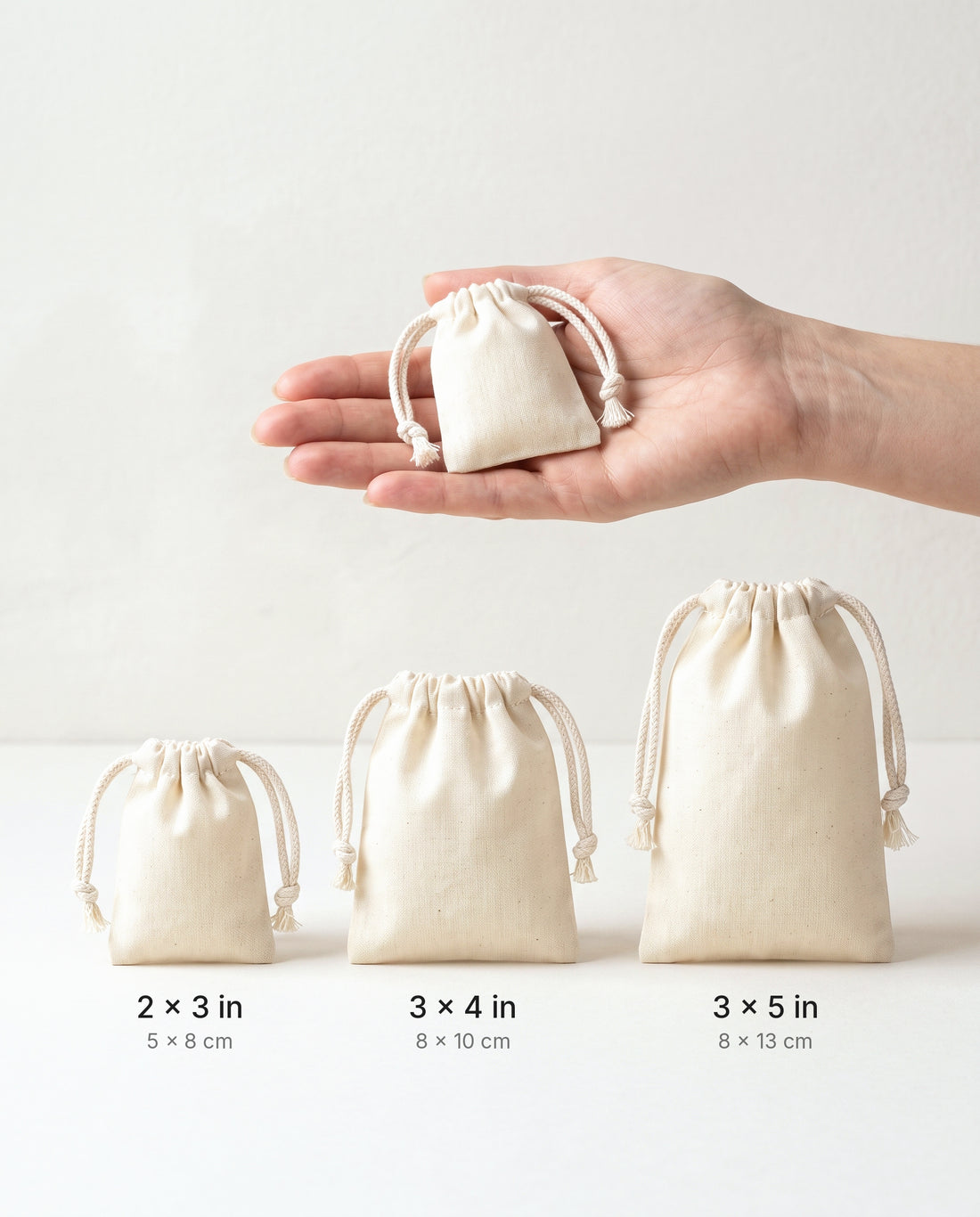 Size comparison of natural muslin drawstring bags: 2×3, 3×4 and 3×5 in
