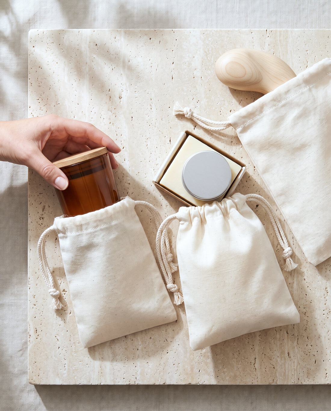 Natural cotton muslin drawstring bags in use for candles, gift sets and small decor