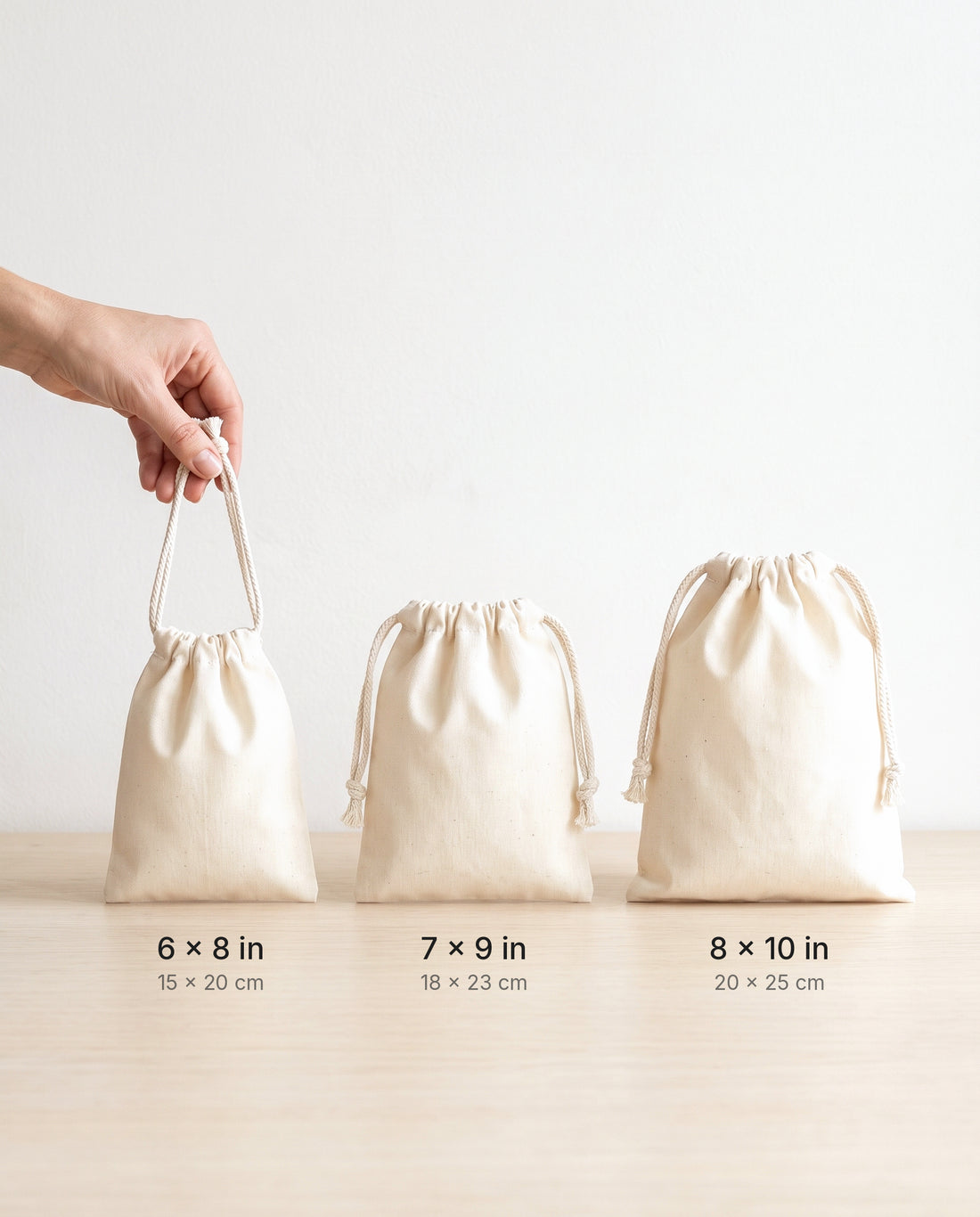 Size comparison of natural muslin drawstring bags: 6×8, 7×9 and 8×10 in
