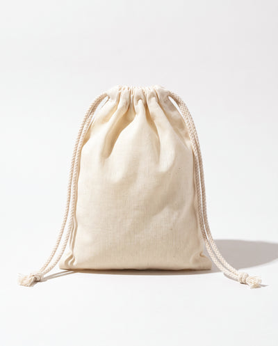 Plain natural cotton muslin double drawstring bag with braided cotton cords, white background