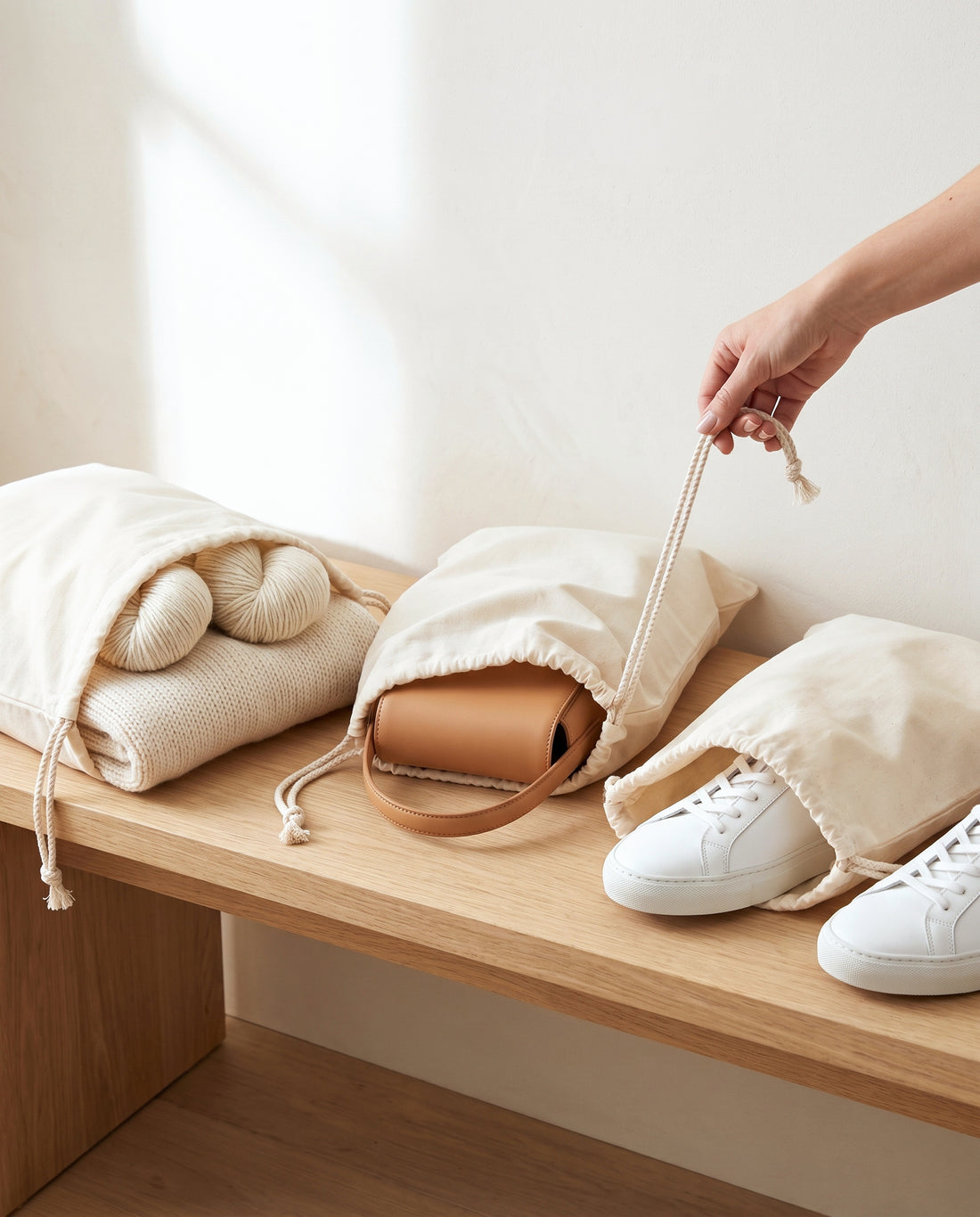 Natural cotton muslin drawstring bags in use for knitwear, handbags and sneakers