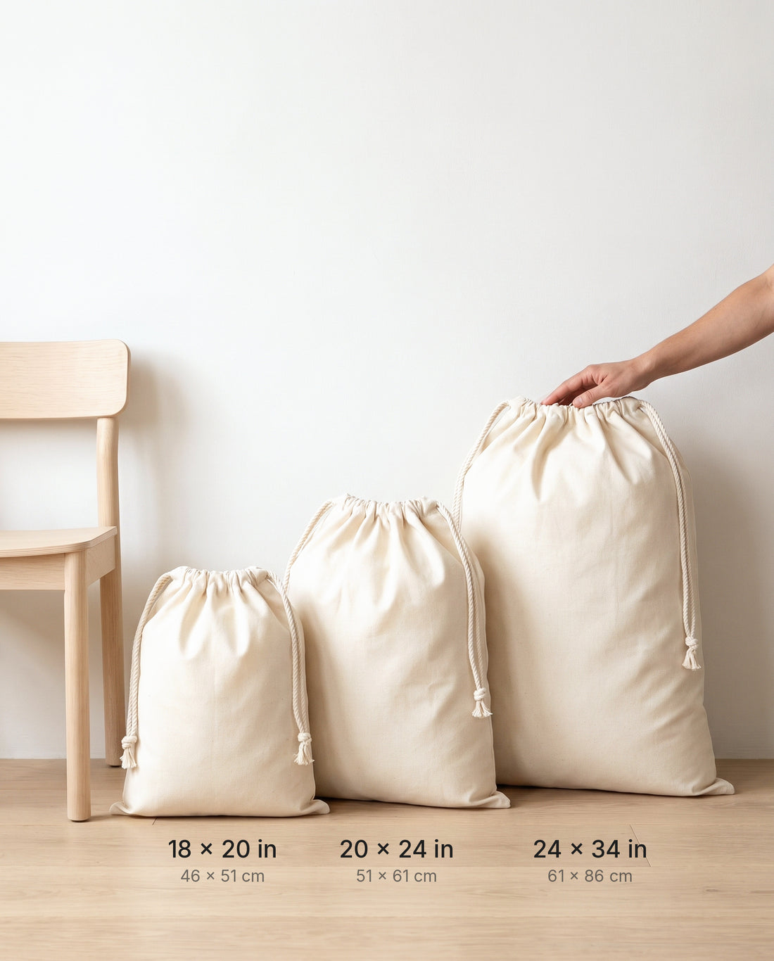 Size comparison of natural muslin drawstring bags: 18×20, 20×24 and 24×34 in
